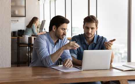 men talking at a coworking space