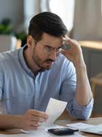 distressed man looking at the financials